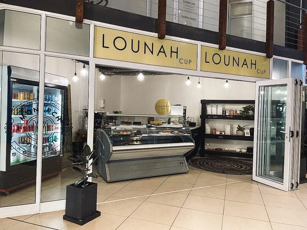 The Lounah Cup counter inside a Swakopmund shopping centre, with a display fridge and gold signage.