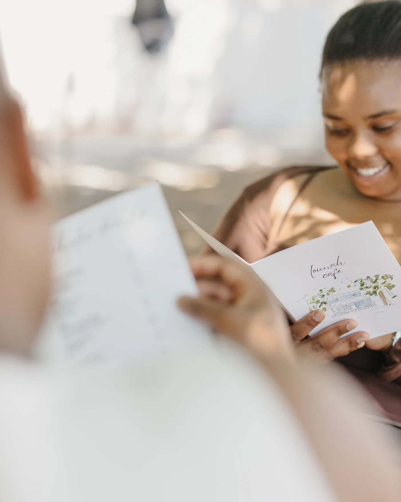 A guest smiling while reading the printed menu.